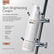 A 15ml bottle of Rhama Skin +16 Skin Brightening Cream is shown hanging from a chrome stand against a light gray background. The bottle is white with black and orange text.